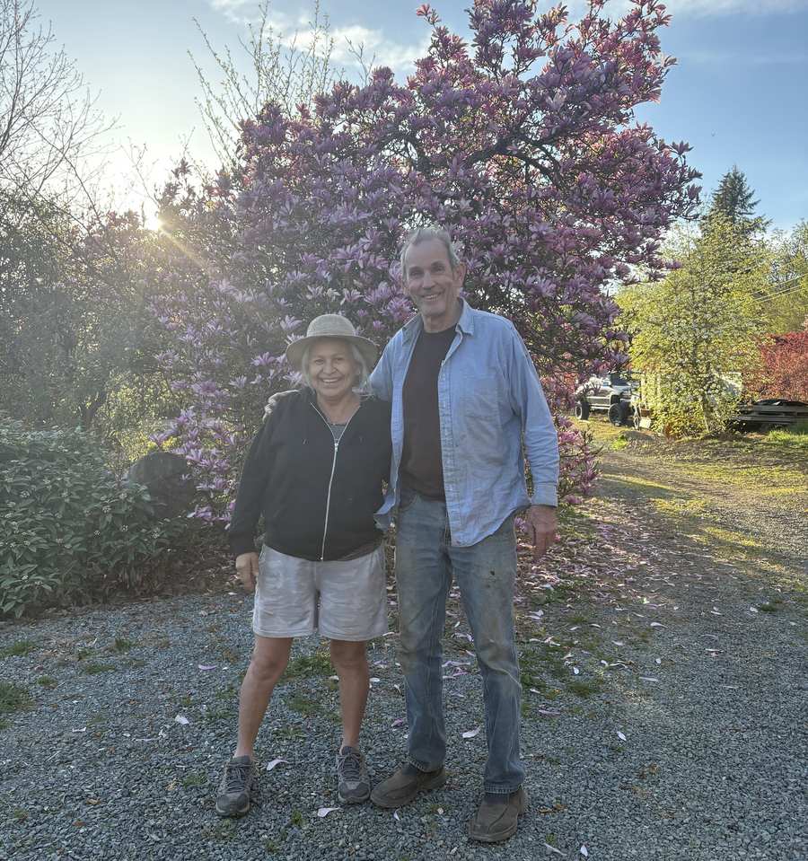 Mum and Dad in front of the big magnolia at the nursery.